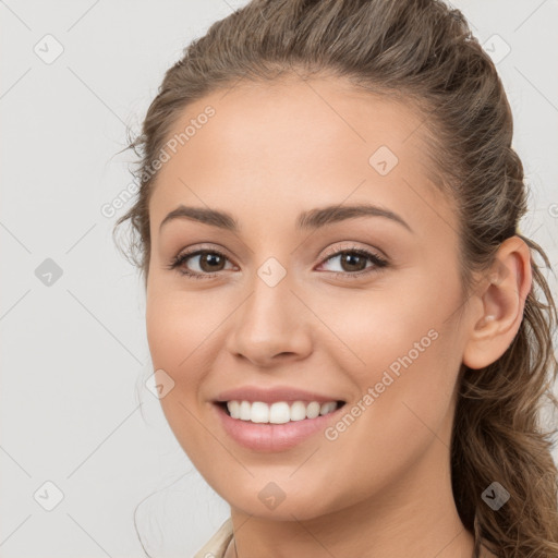 Joyful white young-adult female with long  brown hair and brown eyes