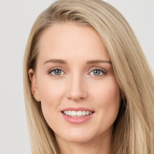 Joyful white young-adult female with long  brown hair and green eyes