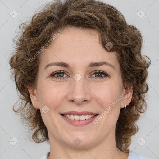 Joyful white young-adult female with medium  brown hair and green eyes