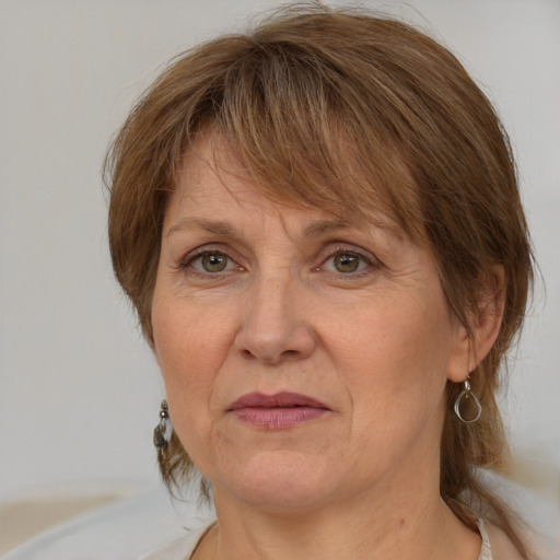 Joyful white adult female with medium  brown hair and grey eyes