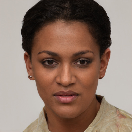 Joyful black young-adult female with short  brown hair and brown eyes