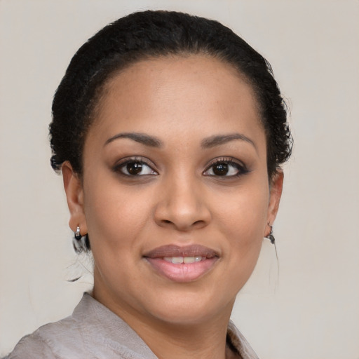 Joyful latino young-adult female with short  black hair and brown eyes