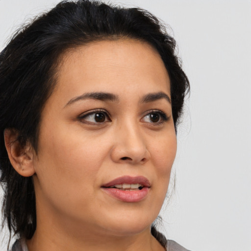 Joyful latino young-adult female with medium  brown hair and brown eyes