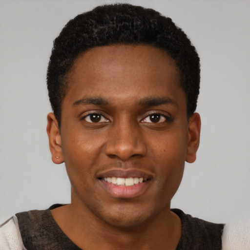 Joyful black young-adult male with short  brown hair and brown eyes