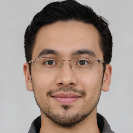 Joyful latino young-adult male with short  black hair and brown eyes