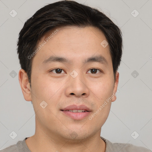 Joyful asian young-adult male with short  brown hair and brown eyes