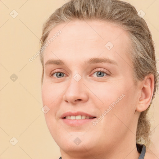 Joyful white young-adult female with medium  brown hair and blue eyes