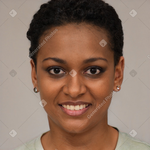 Joyful black young-adult female with short  black hair and brown eyes