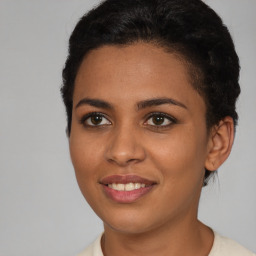 Joyful latino young-adult female with short  brown hair and brown eyes