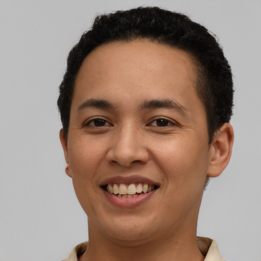 Joyful latino young-adult male with short  black hair and brown eyes