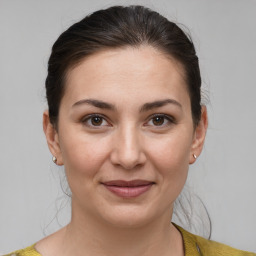 Joyful white young-adult female with medium  brown hair and brown eyes