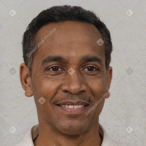 Joyful black adult male with short  brown hair and brown eyes