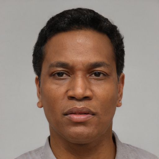 Neutral latino adult male with short  black hair and brown eyes