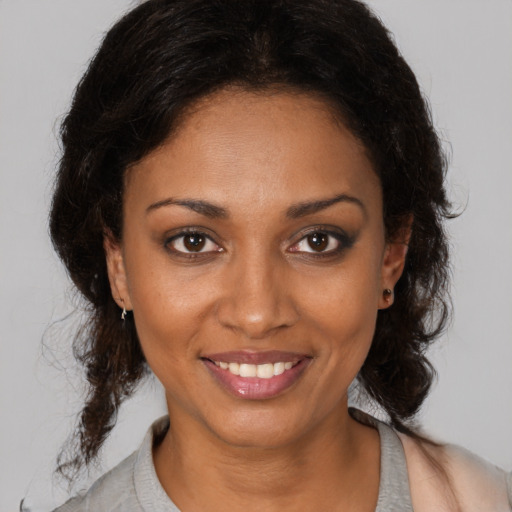 Joyful black young-adult female with medium  brown hair and brown eyes