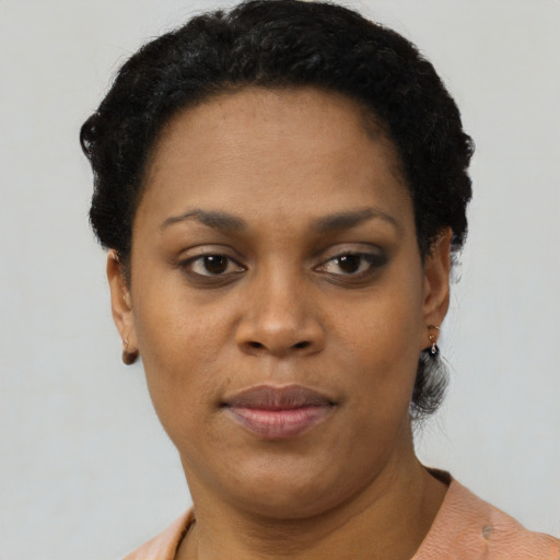 Joyful black young-adult female with short  black hair and brown eyes