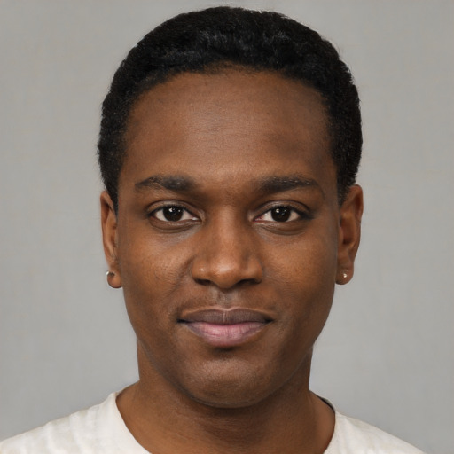Joyful black young-adult male with short  black hair and brown eyes