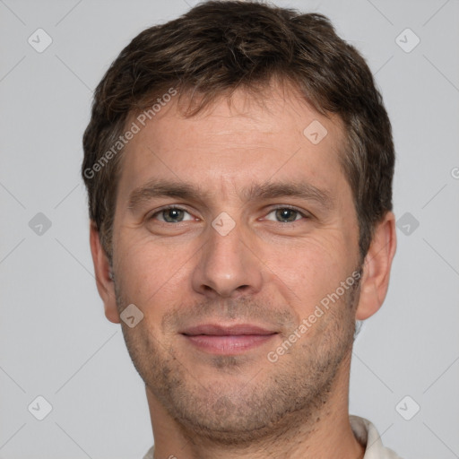 Joyful white adult male with short  brown hair and brown eyes