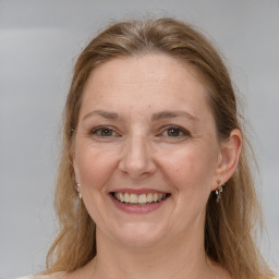 Joyful white adult female with long  brown hair and grey eyes