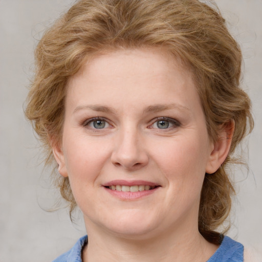 Joyful white young-adult female with medium  brown hair and blue eyes