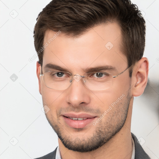 Joyful white young-adult male with short  brown hair and brown eyes