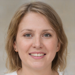 Joyful white young-adult female with medium  brown hair and blue eyes