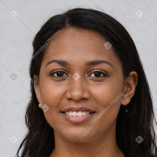 Joyful black young-adult female with long  brown hair and brown eyes