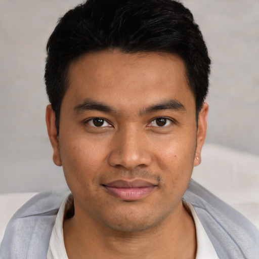 Joyful asian young-adult male with short  black hair and brown eyes