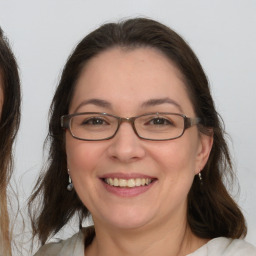 Joyful white adult female with medium  brown hair and brown eyes