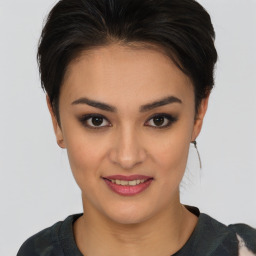 Joyful asian young-adult female with short  brown hair and brown eyes