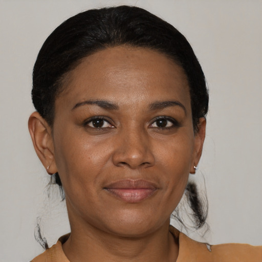 Joyful black adult female with short  black hair and brown eyes