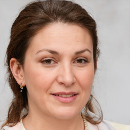 Joyful white adult female with medium  brown hair and brown eyes