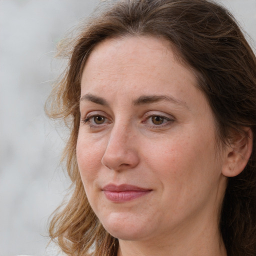 Joyful white adult female with long  brown hair and brown eyes