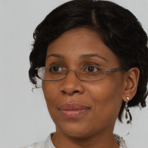 Joyful black adult female with medium  brown hair and brown eyes