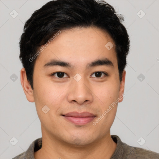 Joyful asian young-adult male with short  black hair and brown eyes