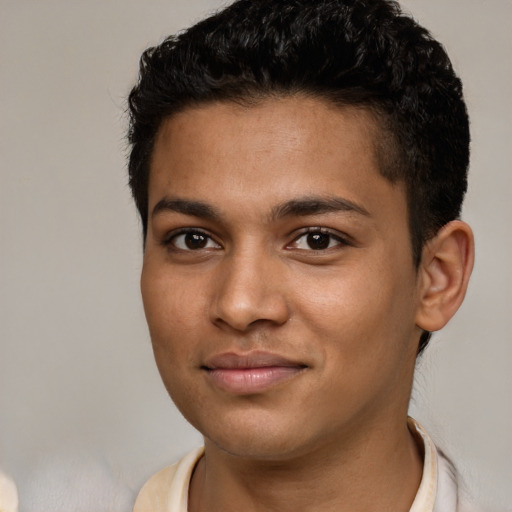 Joyful black young-adult male with short  brown hair and brown eyes