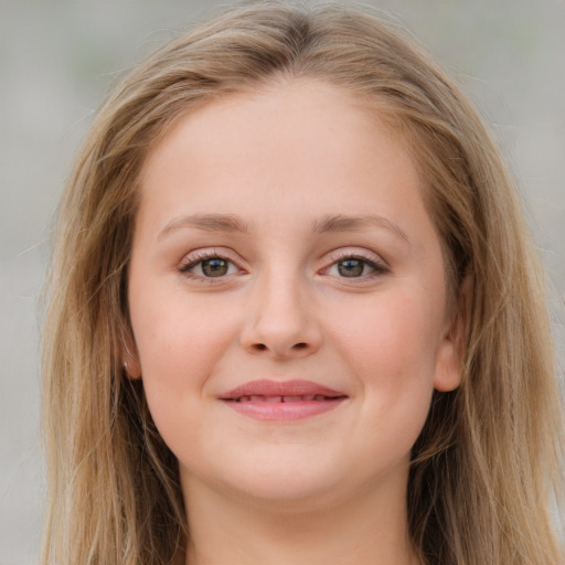 Joyful white young-adult female with long  brown hair and blue eyes