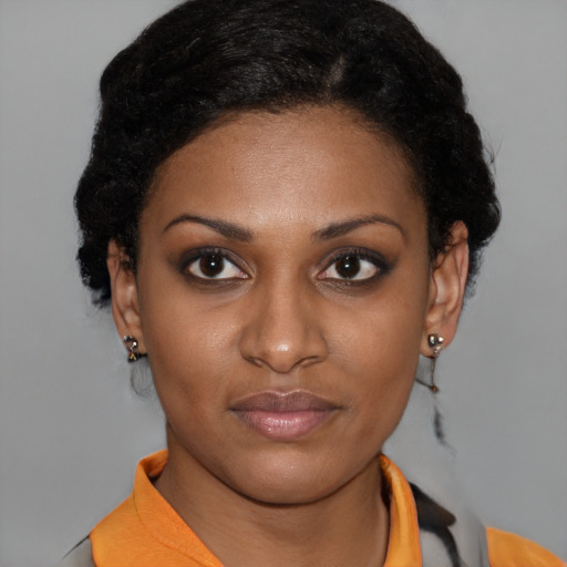 Joyful latino young-adult female with short  brown hair and brown eyes