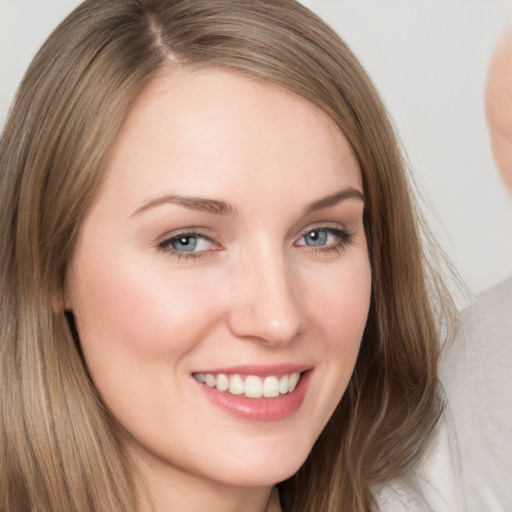 Joyful white young-adult female with long  brown hair and grey eyes