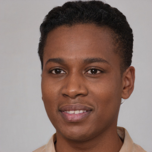 Joyful black young-adult female with short  brown hair and brown eyes