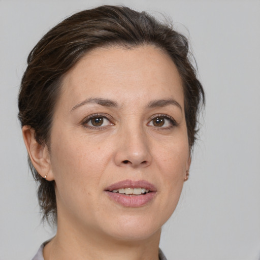 Joyful white adult female with medium  brown hair and brown eyes