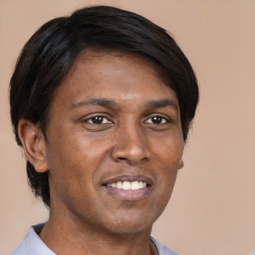 Joyful asian young-adult male with short  brown hair and brown eyes