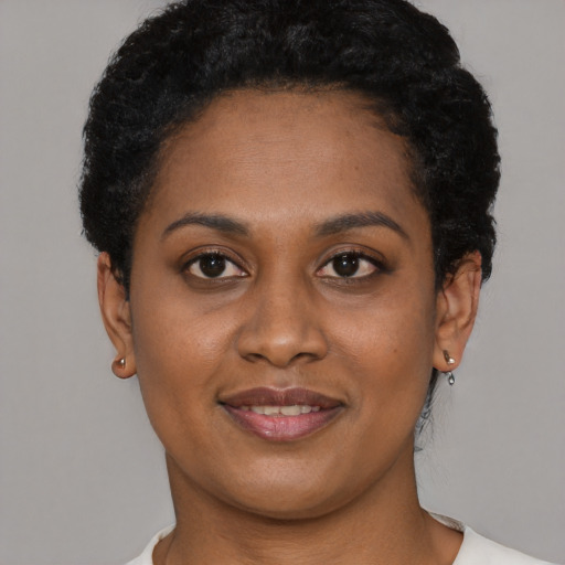 Joyful latino young-adult female with short  black hair and brown eyes