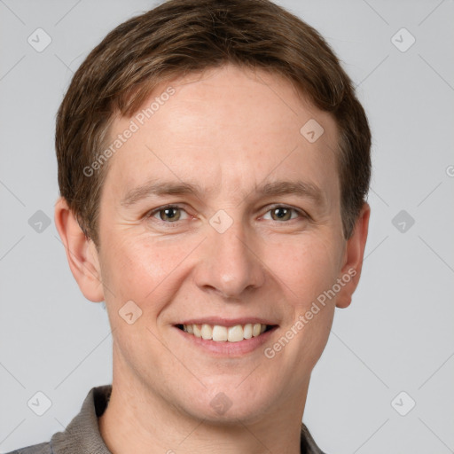 Joyful white adult male with short  brown hair and grey eyes