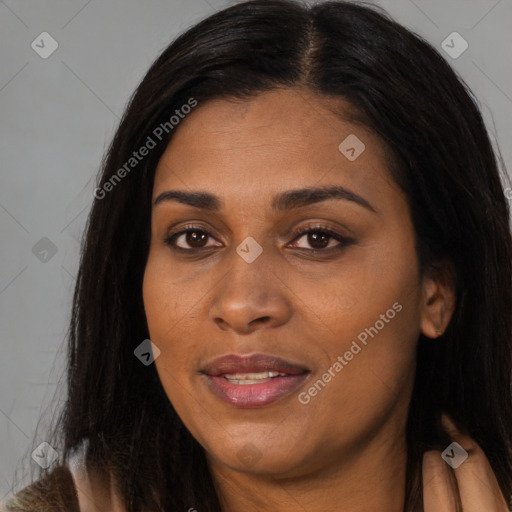 Joyful black young-adult female with long  brown hair and brown eyes