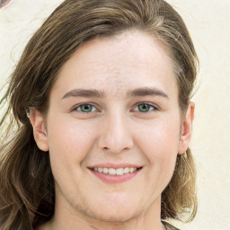 Joyful white young-adult female with long  brown hair and green eyes