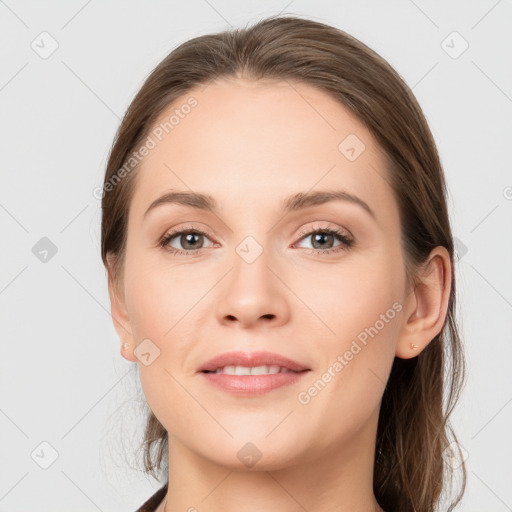 Joyful white young-adult female with long  brown hair and grey eyes