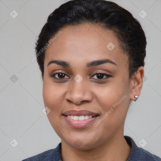 Joyful black young-adult female with short  brown hair and brown eyes