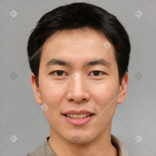 Joyful asian young-adult male with short  brown hair and brown eyes