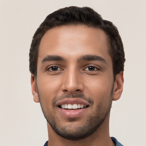 Joyful white young-adult male with short  black hair and brown eyes