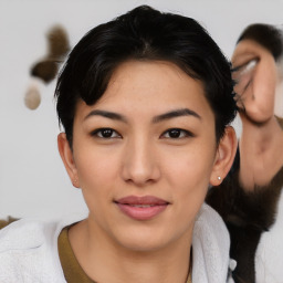 Joyful asian young-adult female with medium  black hair and brown eyes